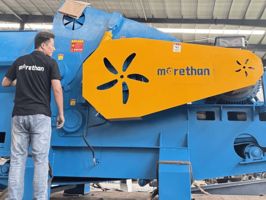 Morethan worker inspect wood crusher before container loading