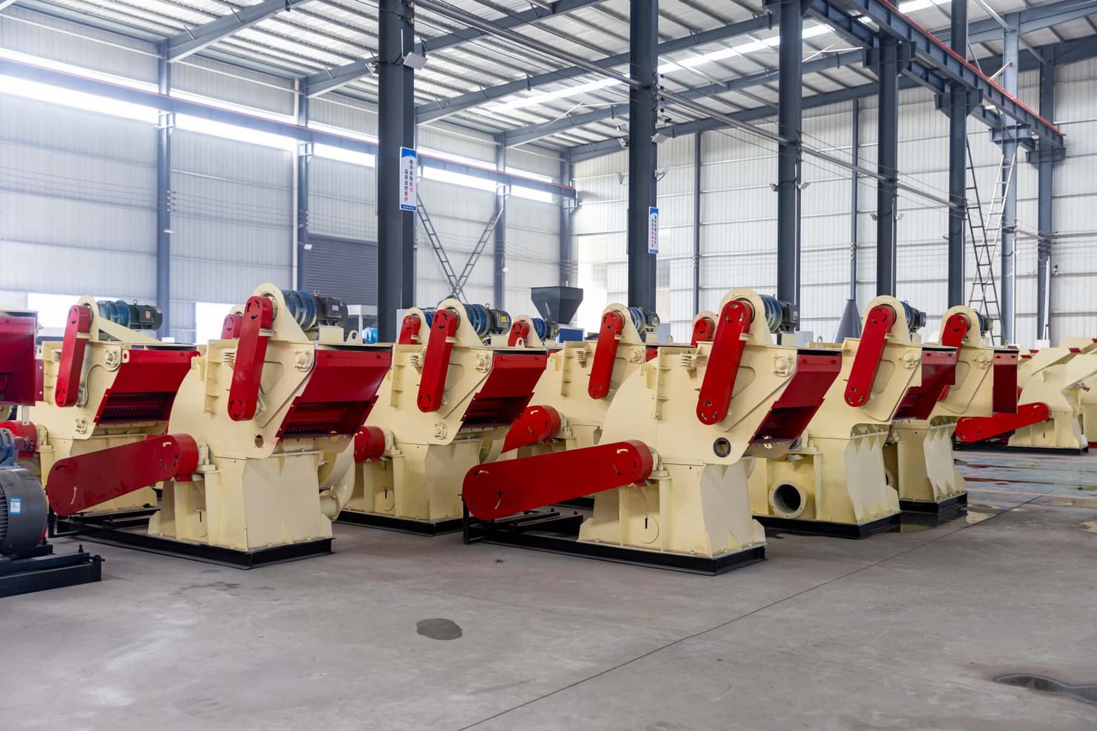 Batch wood crusher machines displayed inside manufacturing workshop