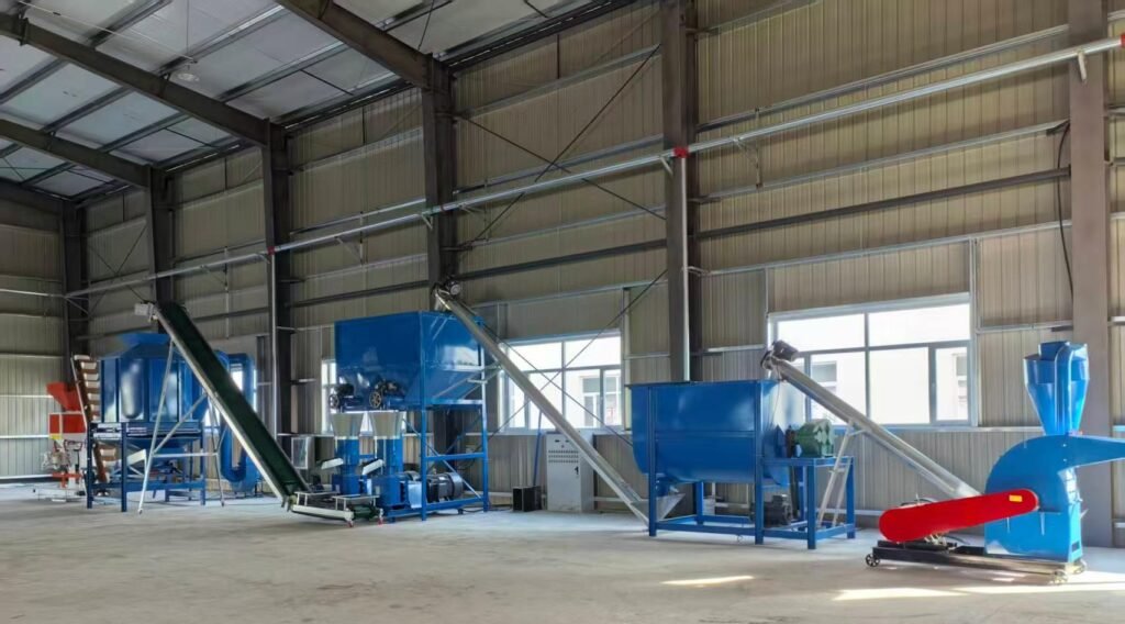 Small flat die feed pellet mill running for livestock feed making at farm workshop